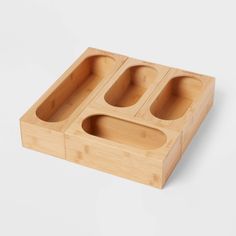 three compartments in a bamboo tray on a white surface