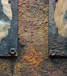 two pieces of metal on the side of a building with rust and paint all over it