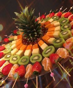 a platter filled with fruit and veggies on skewers for a jewish new year's eve party