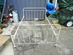 an old metal bed frame sitting on the ground