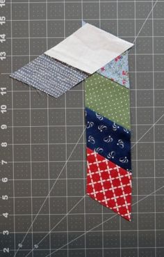 a close up of a piece of fabric on a cutting board with scissors and ruler