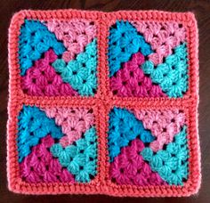 a crocheted square with four squares in the center and two hearts on each side