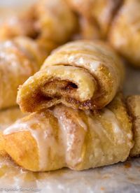 several pastries stacked on top of each other with icing and cinnamon in the middle