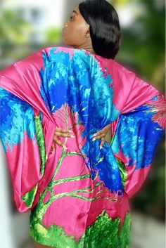 Stay cool and stylish in the Portofino Kimono. Crafted from a luxurious blend of Viscose and Silk, this show-stopping piece features a dropped kimono sleeve design and a vibrant abstract print. Its oversized fit fits sizes 2-22, and comes with a sash to accessorize- allowing you to wear the kimono as a dress. Pink Printed Long Sleeve Kimono, Long Sleeve Pink Printed Kimono, Vibrant Spring Kimono With Vibrant Print, Pink Party Kimono, Multicolor Print Kimono With Vibrant Print And Kimono Sleeves, Vibrant Spring Kaftan With Kimono Sleeves, Vibrant Kaftan With Kimono Sleeves For Spring, Spring Party Kaftan With Kimono Sleeves, Chic Multicolor Floral Print Kimono