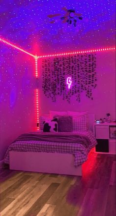 a bed room with a neatly made bed and purple lights on the wall above it