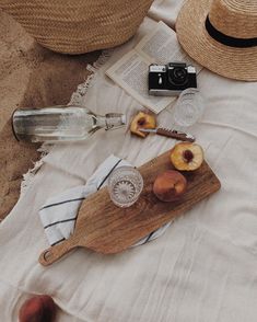 a wooden cutting board sitting on top of a white table cloth next to an empty bottle