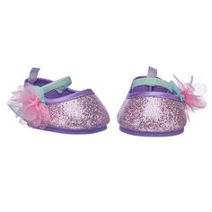 a pair of purple shoes with pink and green bows