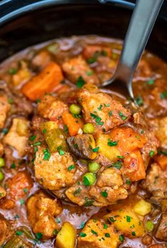 a crock pot filled with meat and vegetables