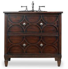 an antique style bathroom vanity with two sinks and wood accents on the front, in dark brown