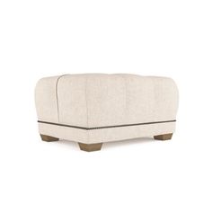 a white couch sitting on top of a wooden table