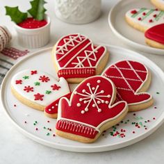 three decorated christmas cookies on a plate next to other holiday decorations and decorating items