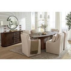 a dining room table with chairs and a mirror