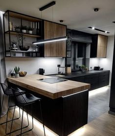 a modern kitchen with black cabinets and wooden counter tops, along with bar stools