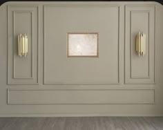 an empty room with white walls and gold trim on the doors is seen in this image