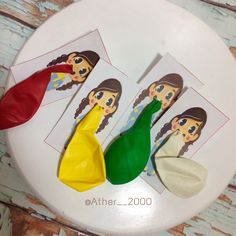 three different colored plastic spoons sitting on top of a white plate