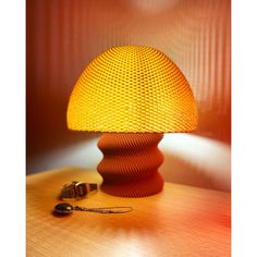 a yellow lamp sitting on top of a wooden table