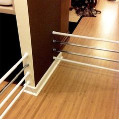 a close up of a metal rail on a wooden floor next to a cabinet door