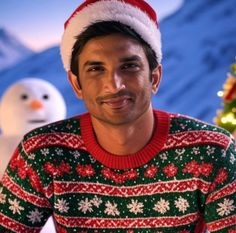 a man wearing a christmas sweater and santa hat