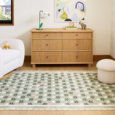 a living room with a dresser and chair