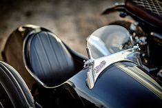 the side view of a black motorcycle with chrome trims and seat covers on it