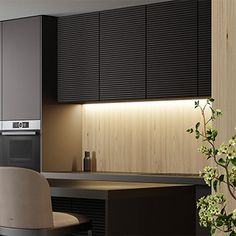 a modern kitchen with black cabinets and white counter tops, along with a dining room table