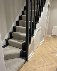 a staircase with carpeted steps leading up to the second floor