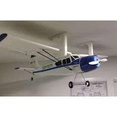 an airplane hanging from the ceiling in a room