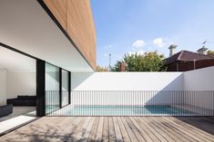 an outdoor swimming pool next to a wooden deck