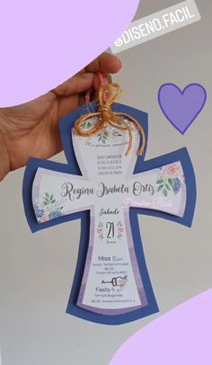 a person holding up a cross shaped card