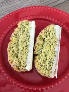 two pieces of food sitting on top of a red plate with white frosting and sprinkles