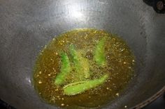 a pan filled with broccoli cooking on top of a stove