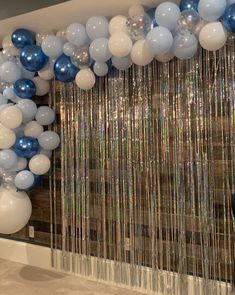 blue and white balloons hanging from the ceiling