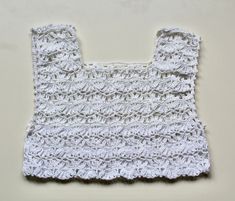 White crochet top  Available in UK 12 to buy now. See below on how to preorder if you would like a different size: We're a UK brand that specialise in handmade clothing. All our items are created by Anne Lee, with help from Amy. Our styles reflect hippie/bohemian fashion and we like to mix bright colours and patterns to create one of a kind items.  Every item is slightly different and unique, all handmade personally for you with love. This means we only sell in limited quantities and not every size/style is listed. If you are interested in an item and would like to pre-order this in your size, please send us a message. Please check out our other items x White Crochet Sleeveless Crop Top, Handmade White Sleeveless Crochet Top, White Handmade Sleeveless Crochet Top, Cropped Cotton Crop Top With Crochet Lace, White Crochet Lace Crop Top, White Fitted Crochet Lace Crop Top, White Cropped Crop Top With Crochet Lace, Handmade Cotton Crochet Crop Top, White Crochet Trim Crop Top