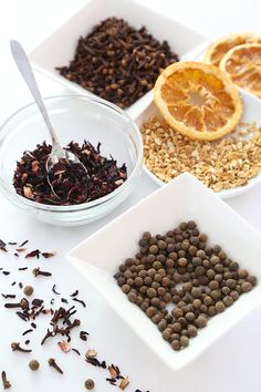 four bowls filled with different types of food and one bowl containing orange slices, granola,