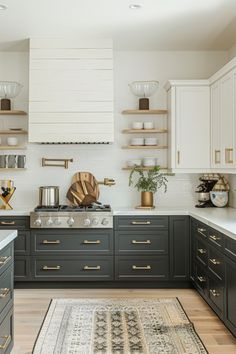 a kitchen with gray cabinets and gold accents