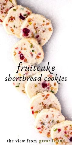 cookies with cranberry and pistachio toppings are arranged on a white surface