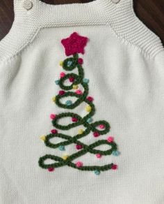 a white sweater with a christmas tree on it