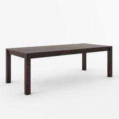 a wooden table sitting on top of a white floor