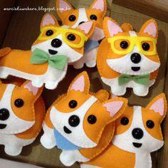 small stuffed corgi dogs wearing sunglasses and bow ties