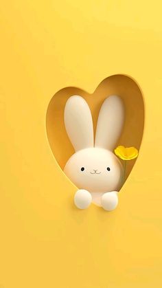 a white rabbit with a yellow flower sticking out of it's hole in the shape of a heart