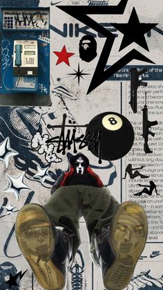 a man with his feet up in the air next to a phone and some graffiti