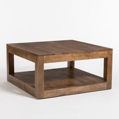 a square wooden table with two shelves on each side and one shelf below the coffee table