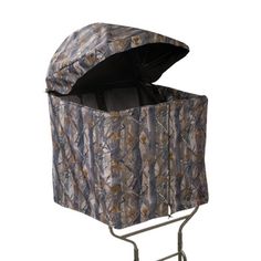 a camo covered storage bin on a metal stand with wheels and an open lid