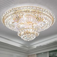 a large crystal chandelier hanging from the ceiling in a room with white walls