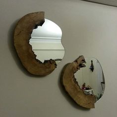 two mirrors that are on the wall next to each other, one is broken in half