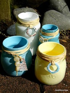 four jars are sitting next to each other on the ground