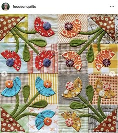 a patchwork quilt with flowers and butterflies on it