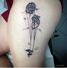 a woman's thigh with tattoos on her legs and flowers in the shape of balloons