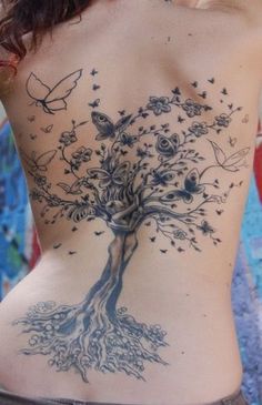 a woman with a tree tattoo on her back