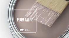 a paint can with a brush in it and the words plum taupe painted on it